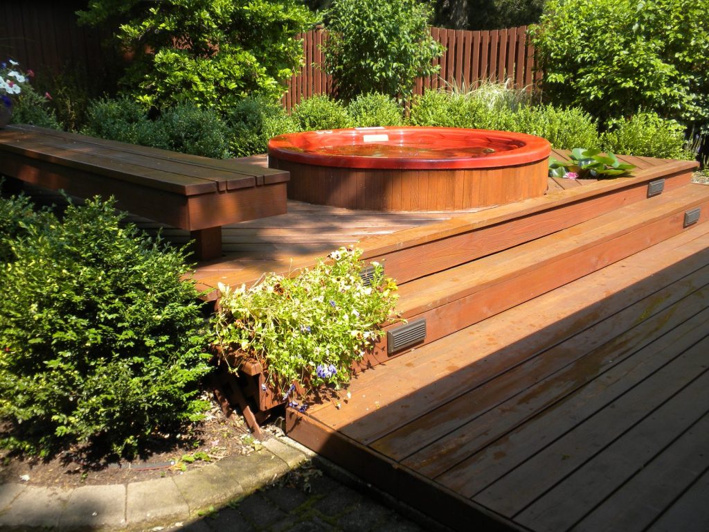 Stained cedar deck with a hot tub platform, North Shore
