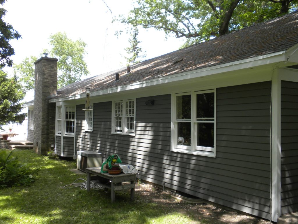 Green Lake lake house after painting: new gray siding with white trim, chimney side