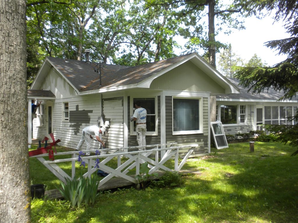 Pete the Painter crew priming the lake house in Green Lake, Wisconsin