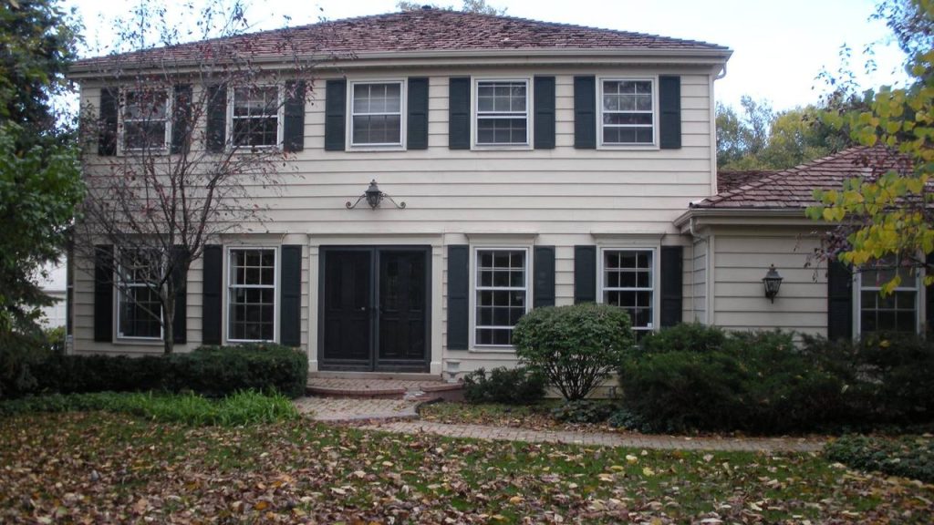 Colonial home exterior with black shutters painted by Pete the Painter
