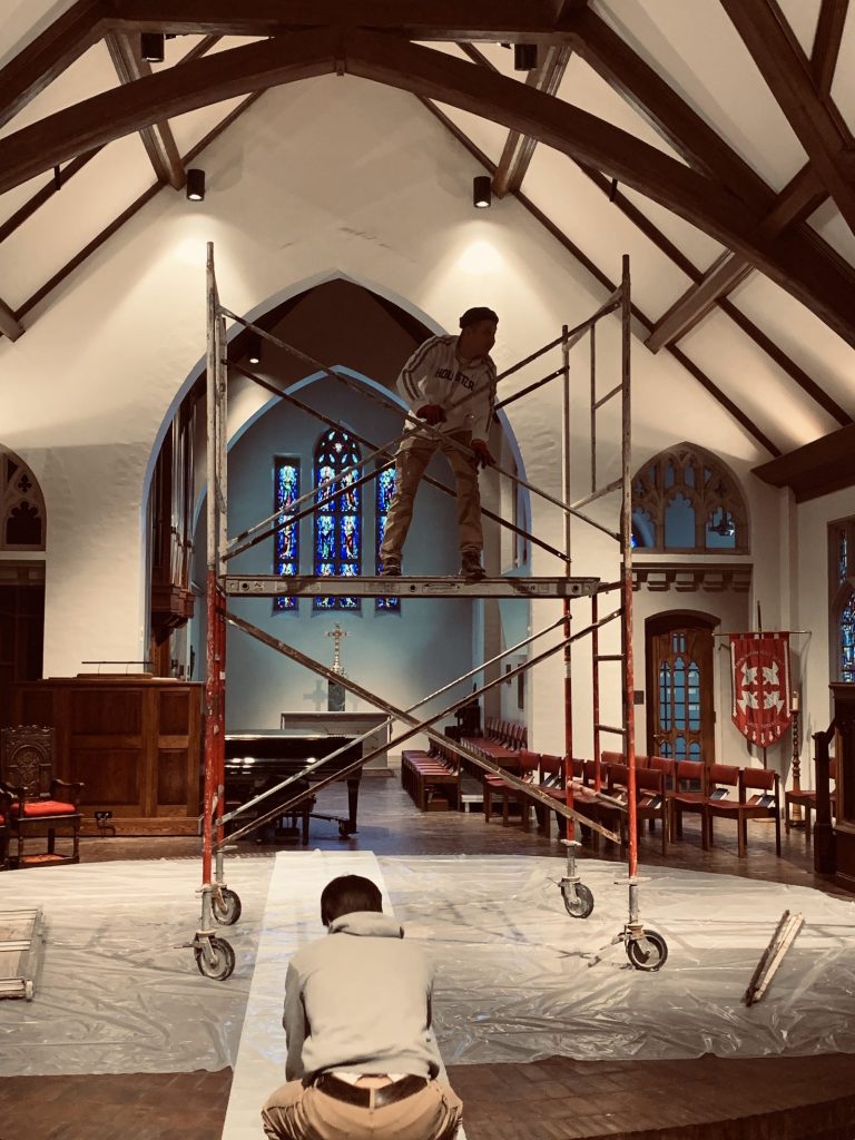 Pete the Painter crew on scaffolding painting a church interior